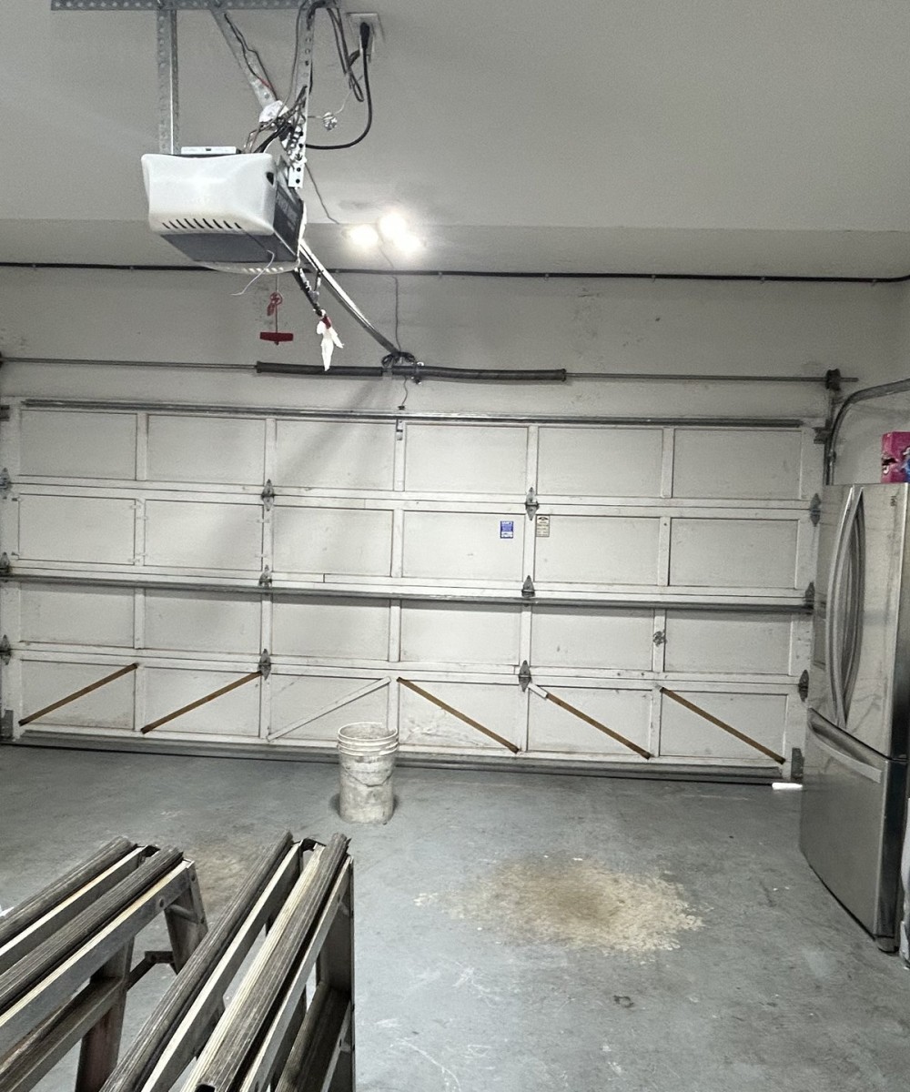 White Hormann 3400 Long Panel garage door with glass top section on a Richmond home