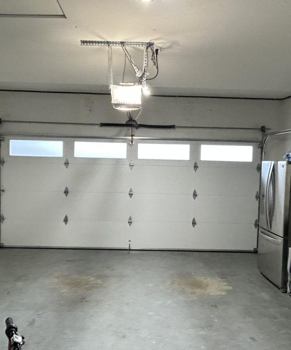 White Hormann 3400 Long Panel garage door with glass top section on a Richmond home