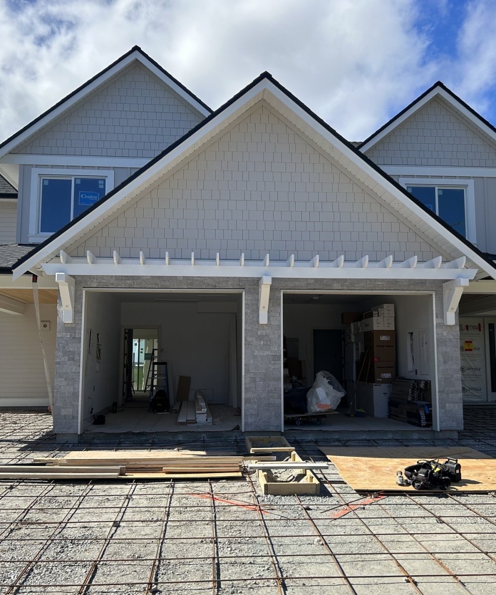 Clopay Coachman Model CG12 white garage doors installed on a new build home in Ladner BC