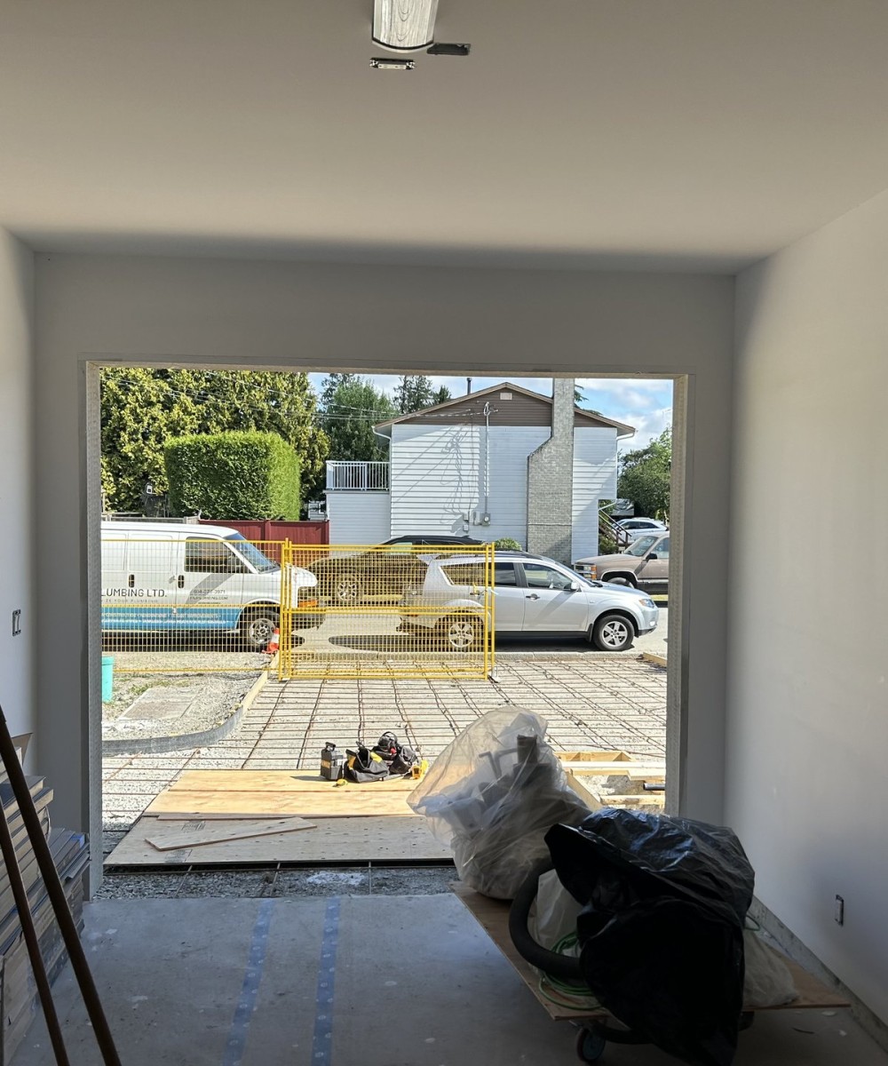 Clopay Coachman Model CG12 white garage doors installed on a new build home in Ladner BC