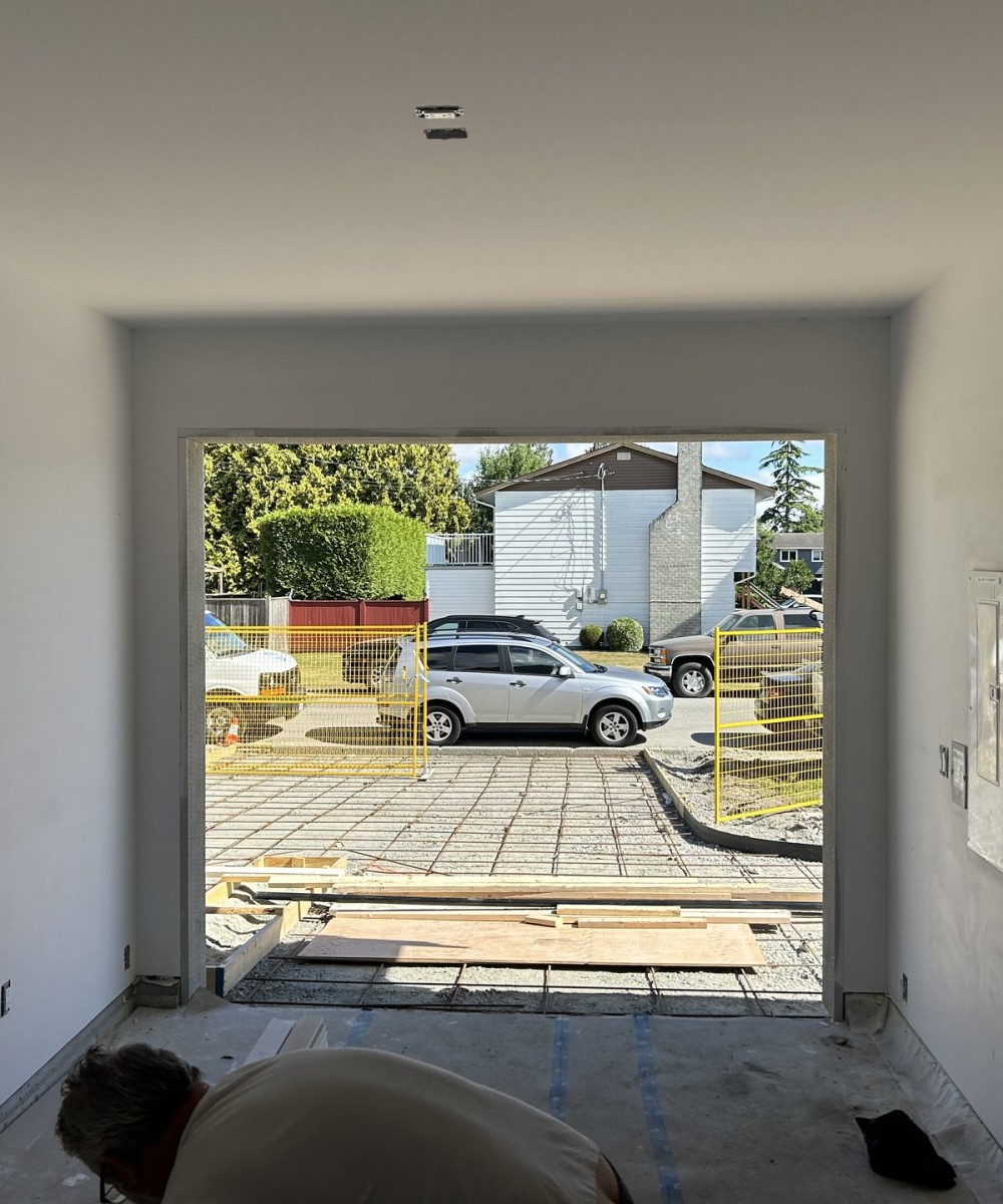 Clopay Coachman Model CG12 white garage doors installed on a new build home in Ladner BC