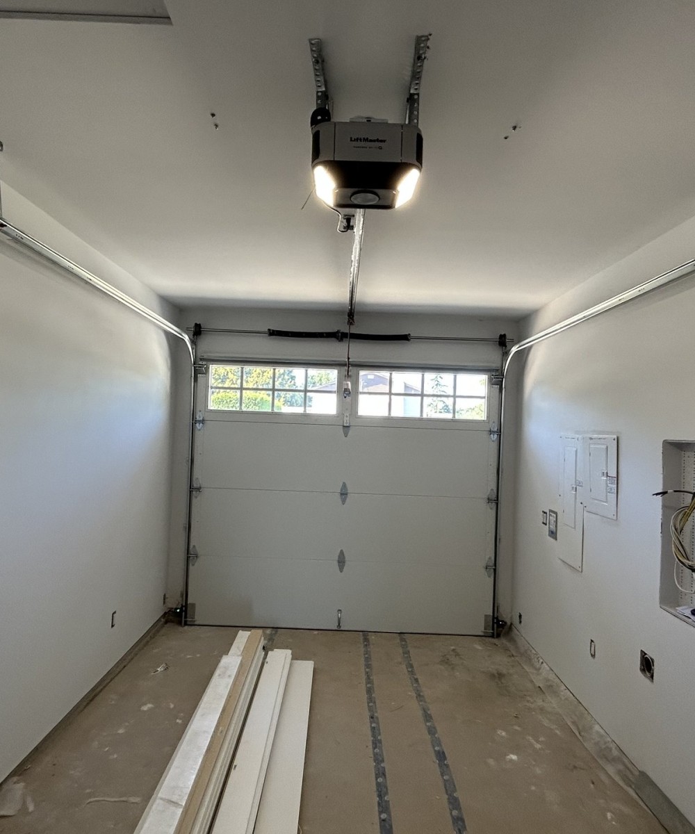 Clopay Coachman Model CG12 white garage doors installed on a new build home in Ladner BC