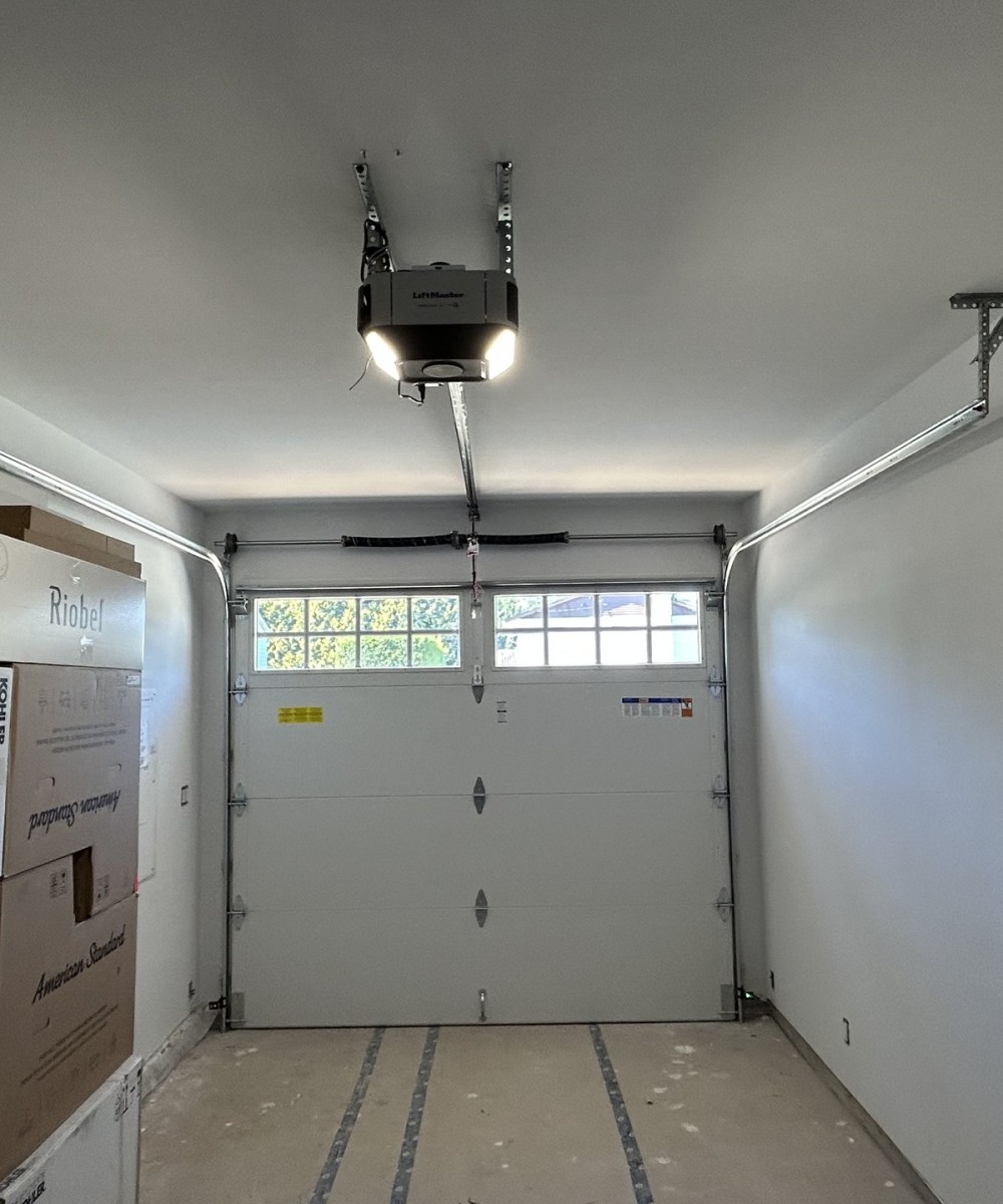 Clopay Coachman Model CG12 white garage doors installed on a new build home in Ladner BC